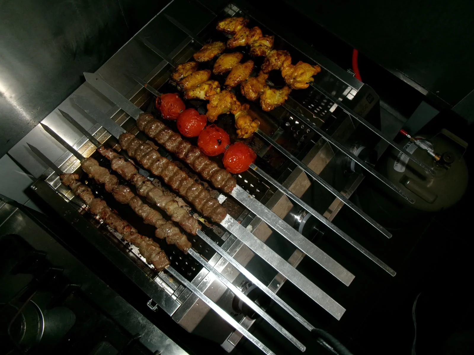 Afghanische Fleischspieße und Tomaten auf dem Grill